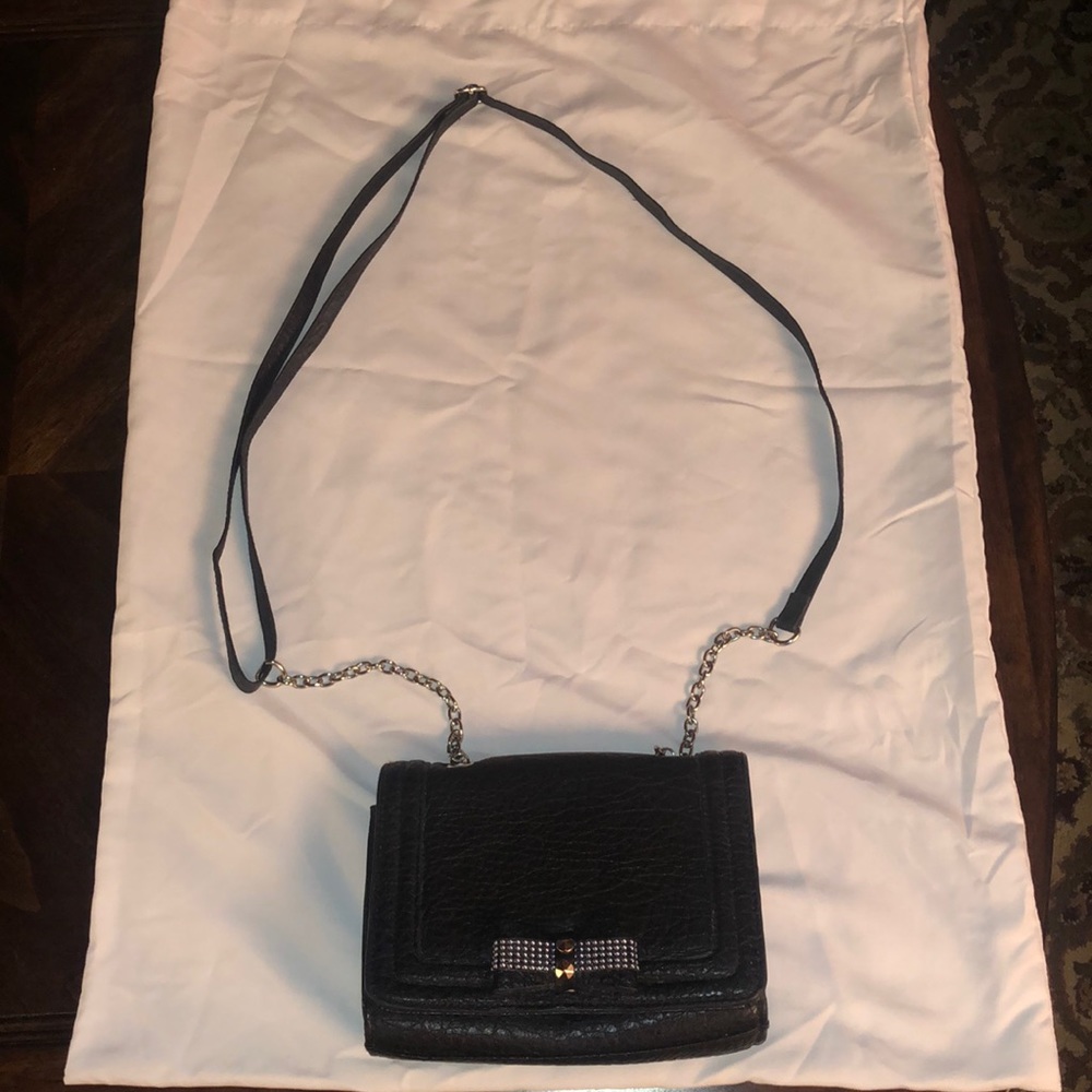 Black clutch with magnetic button closure